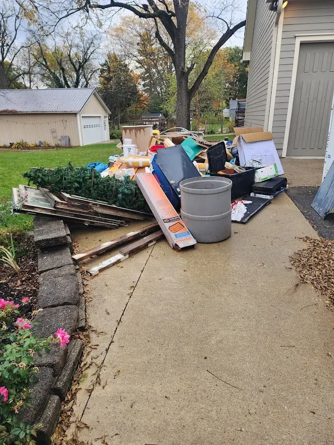 Dumpster being loaded with debris for Residential Dumpster Rental in Mobile